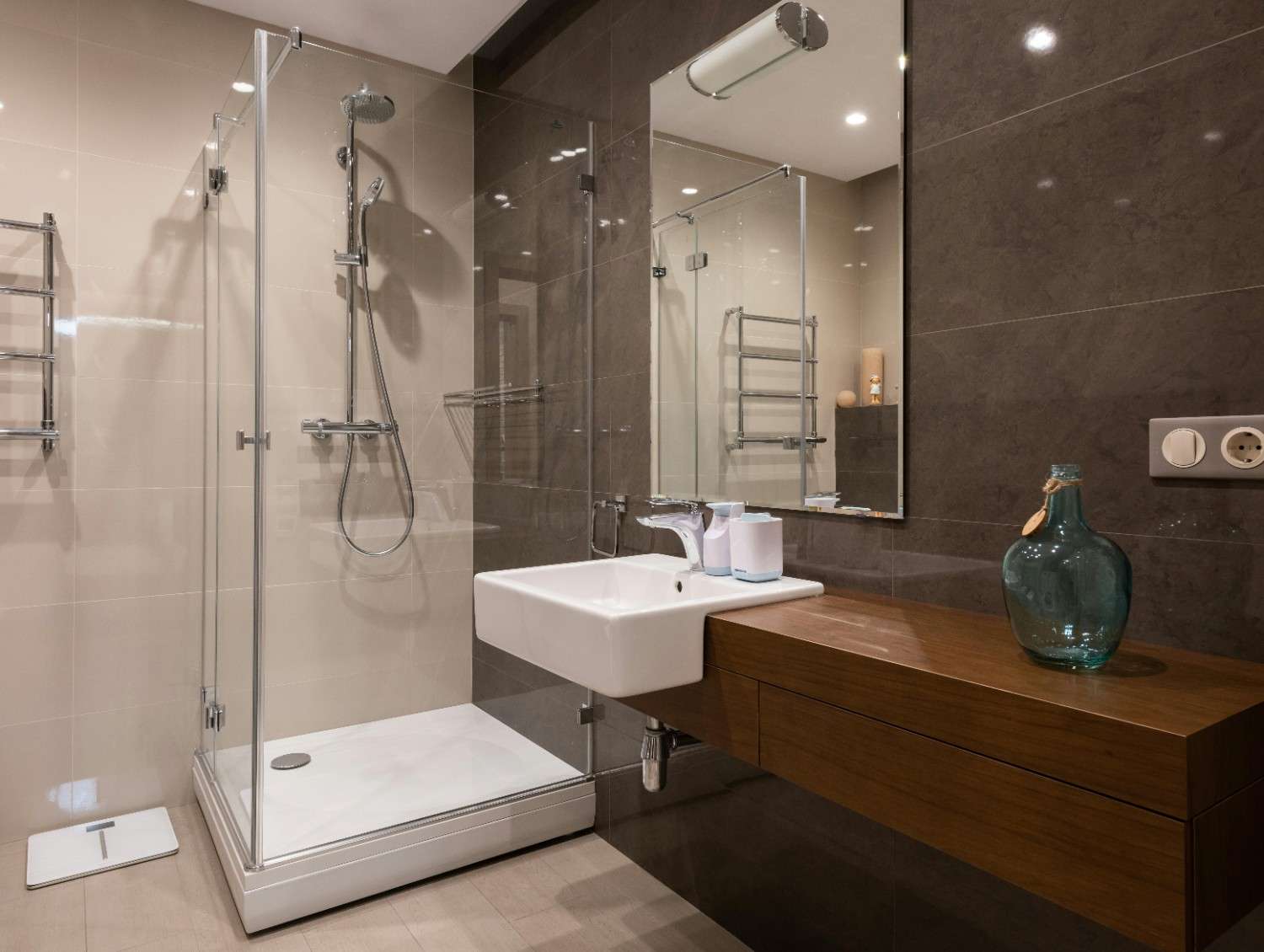 Modern bathroom remodeling in Rochester with glass shower enclosure
